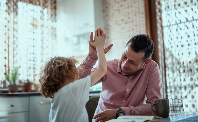 Father giving high-five to daughter